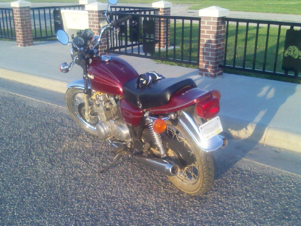 1979 Kawasaki KZ650 motorcycle in burgundy livery parked at the Marysville, KS airport, rear view