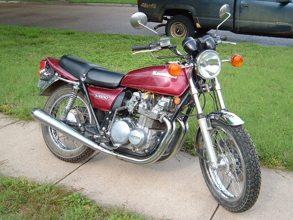 A 1979 KZ650 motorcycle parked on a sidewalk in burgundy livery as purchased.